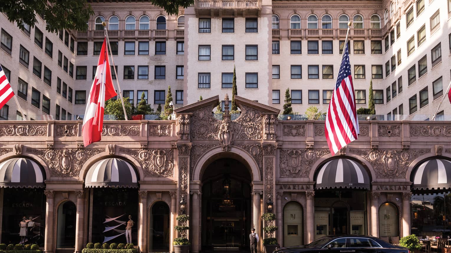 Four Seasons Hotel Beverly Wilshire grand front entrance with American, Canadian flags