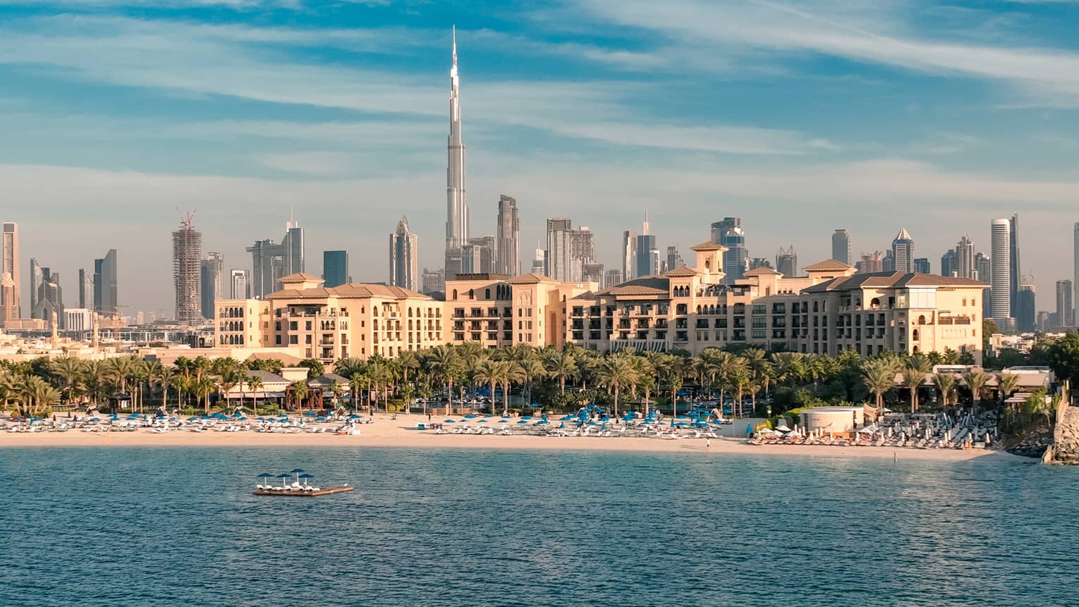 An aerial view of Jumeirah Beach from the sea with a view of downtown in the distance.