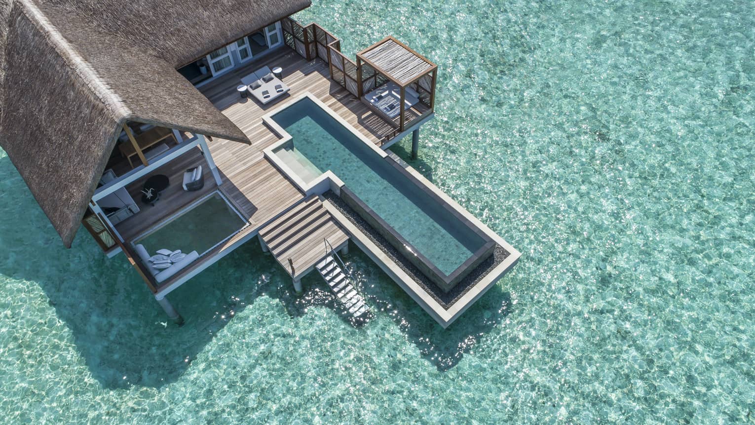 Aerial view of lure island villa with private pool and deck surrounded by crystal ocean