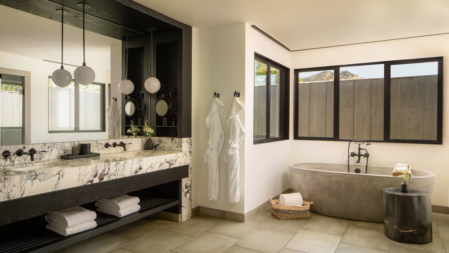Large contemporary bathroom featuring marble double vanity and standalone tub