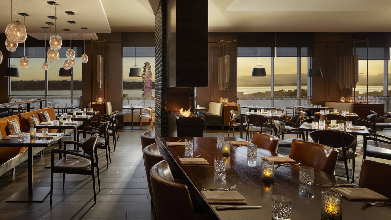 A dimly lit restaurant with large windows.