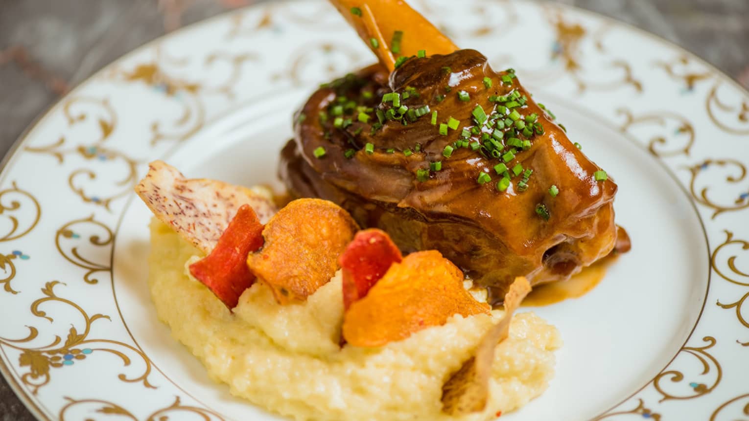 A lamb shank with a side of couscous