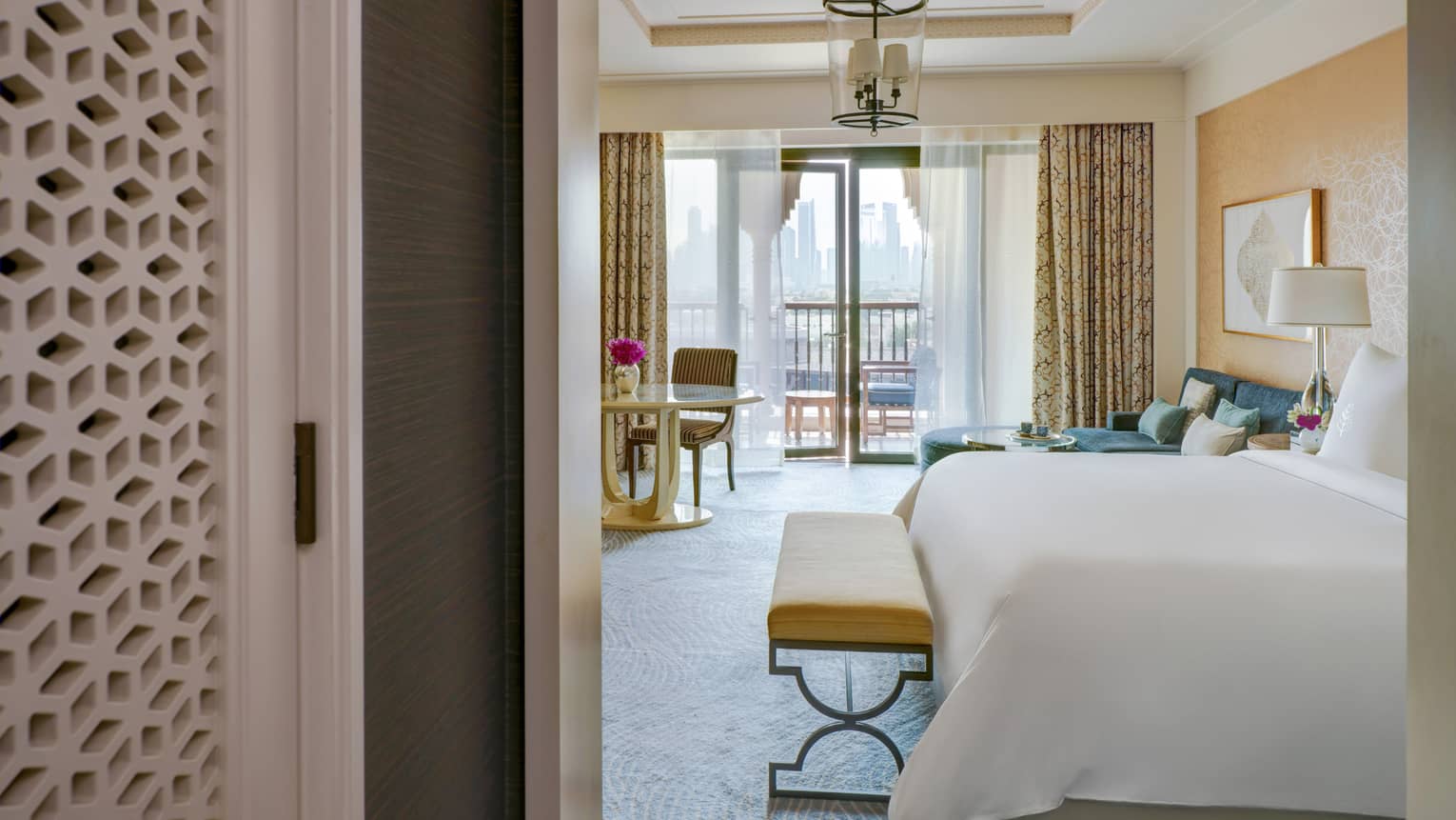Entryway into a bedroom with king bed and walk-out balcony