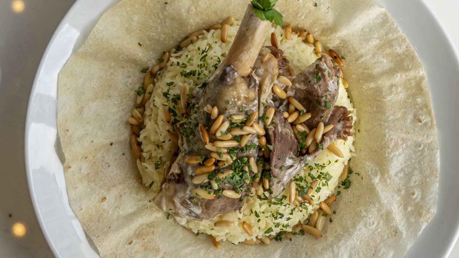 Lamb and rice on a white plate.
