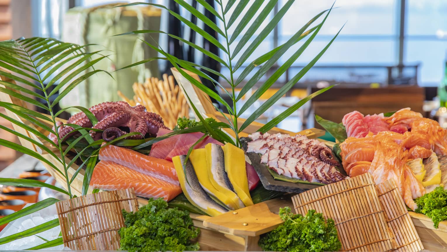 Close-up of a wooden sushi boat laden with vibrant fresh sashimi and octopus, decorated with palm fronds and fresh parsley.