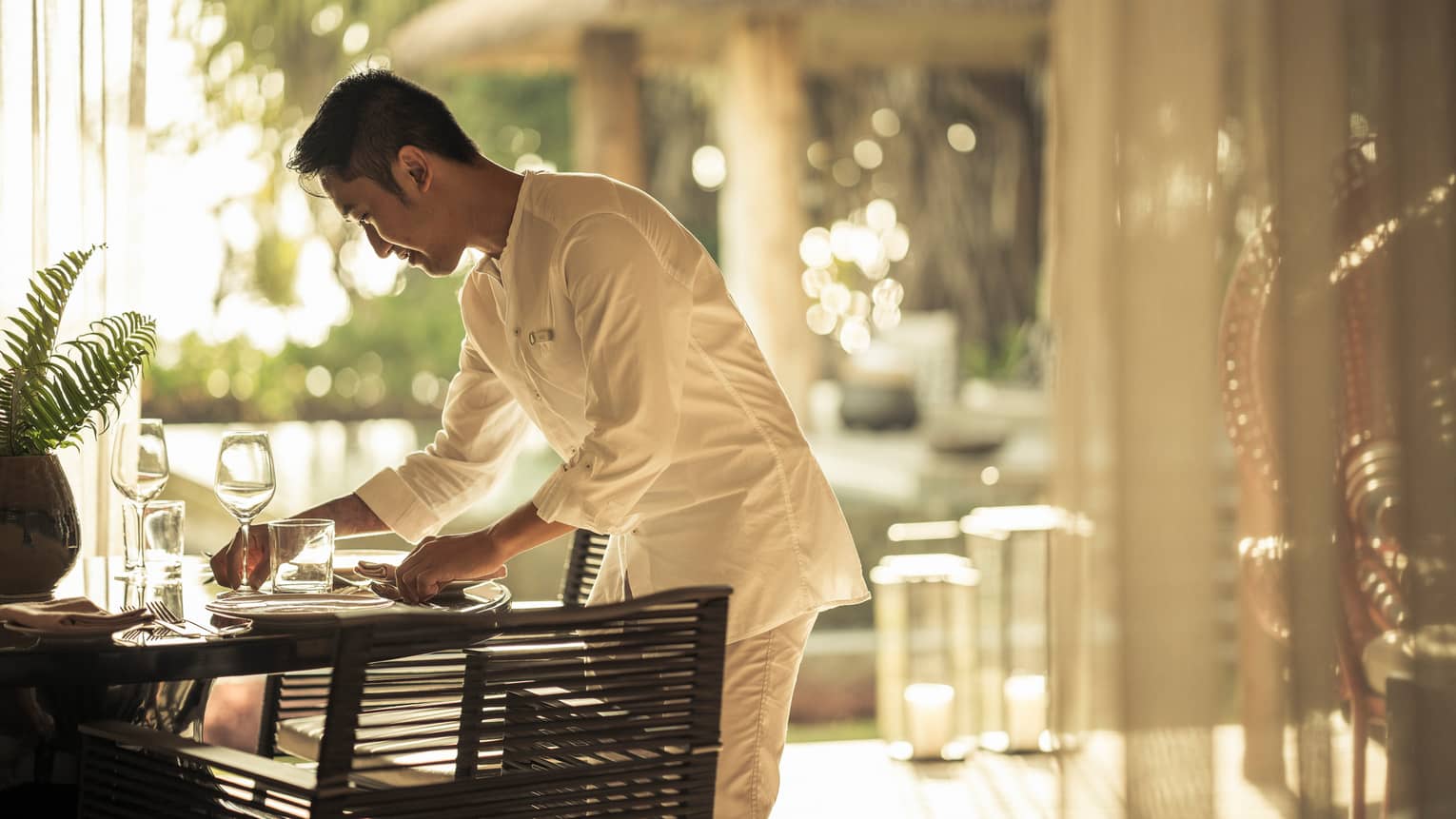 In-villa dining being set up by staff member