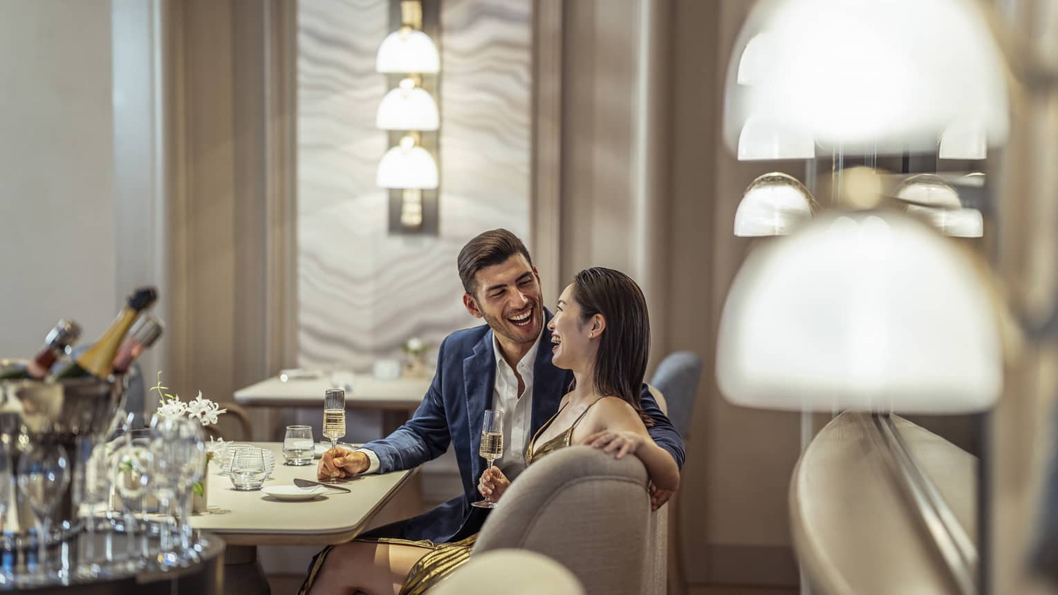 Laughing couple enjoys a romantic meal at S�ZANNE