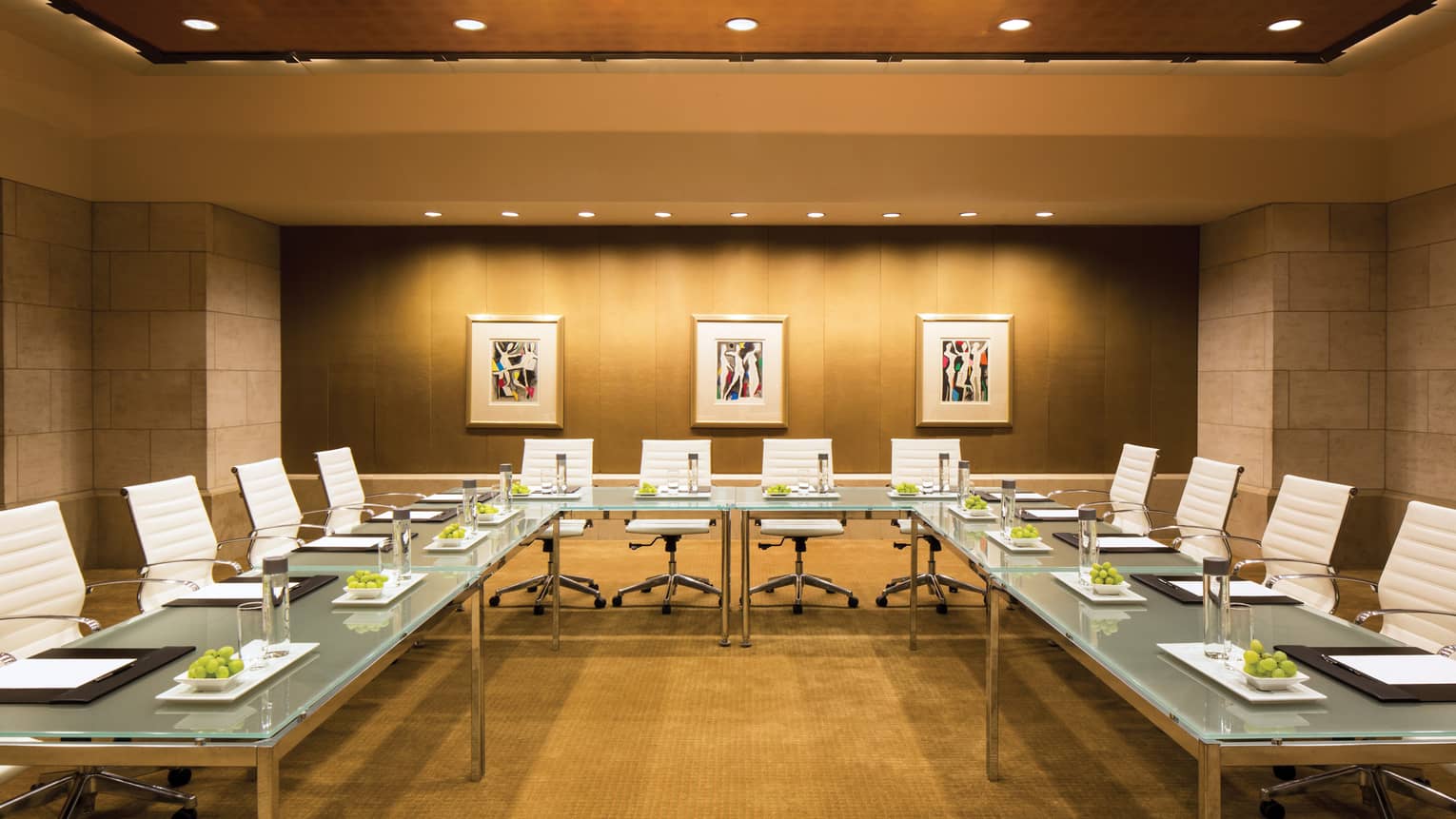 Metropolitan Suite meeting room with large modular glass boardroom tables, white leather chairs