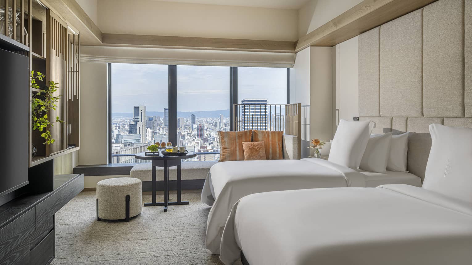 Hotel room with two single beds and Osaka city view