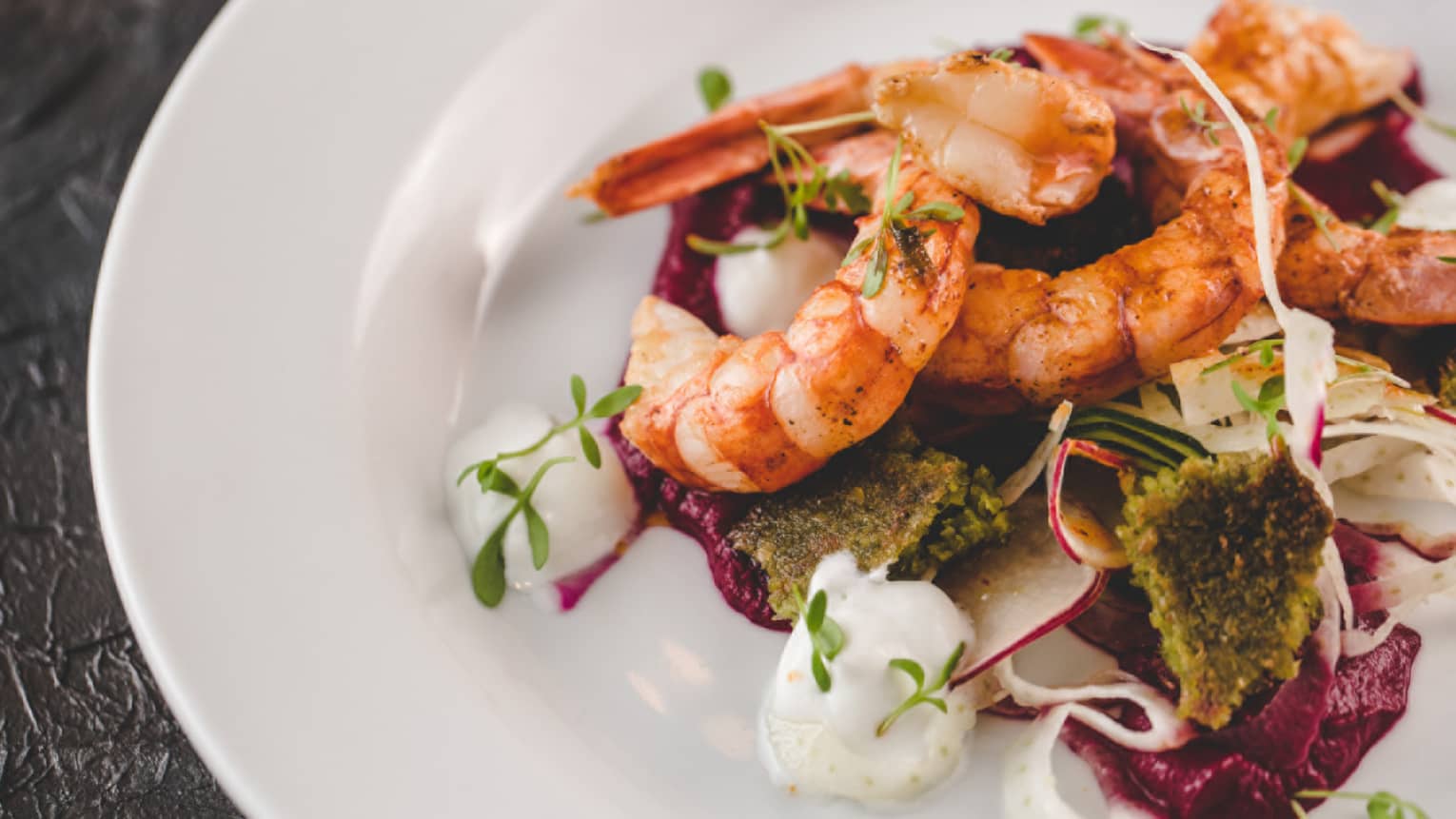 Shrimp served on a bed of vegetables.