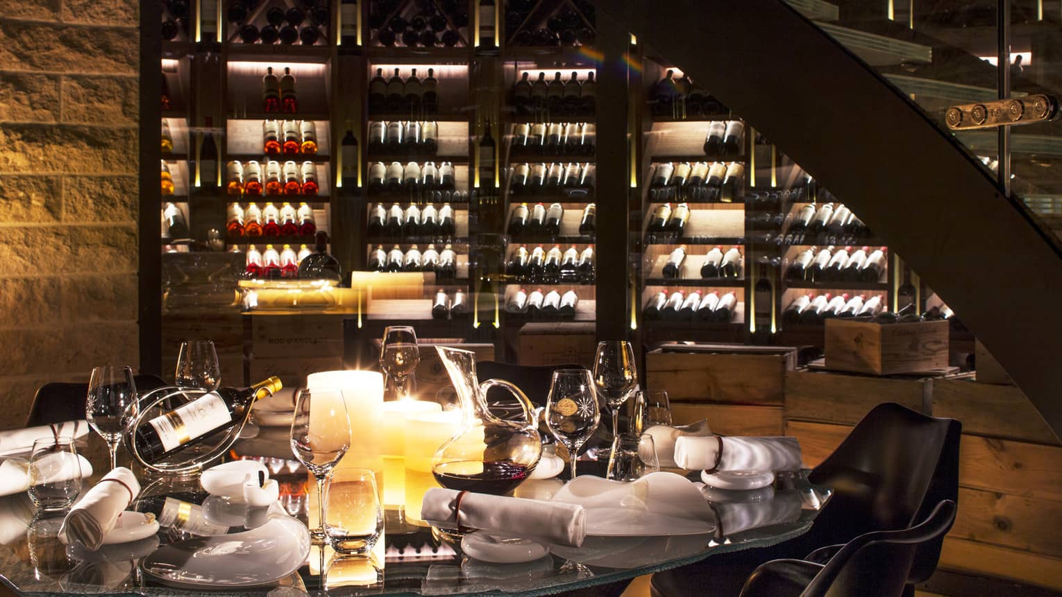 Wine Cellar dining table with bottles of wine, glasses, large candles