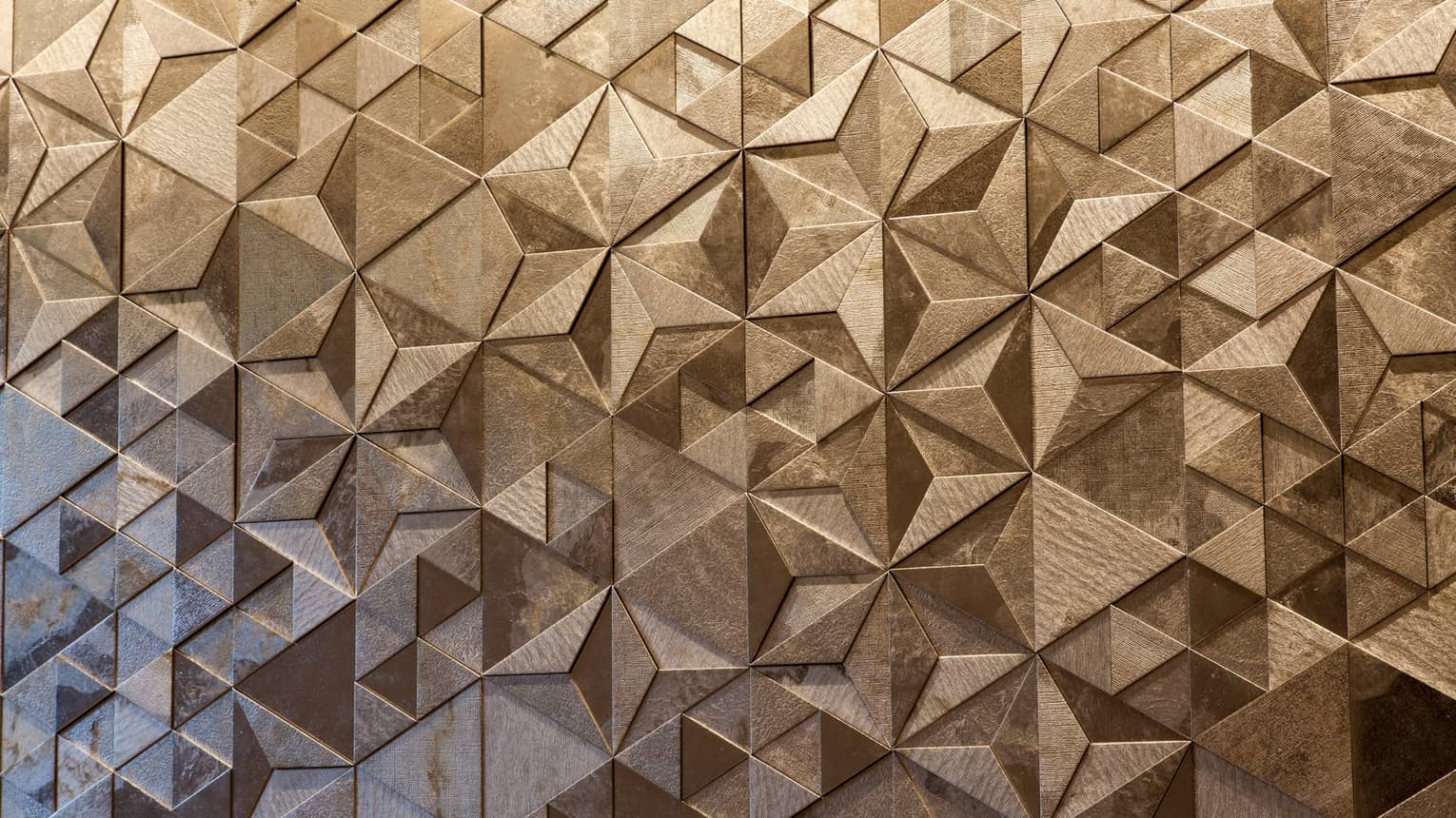 Close-up of Sushi Wakon geometric designs on silver tile wall
