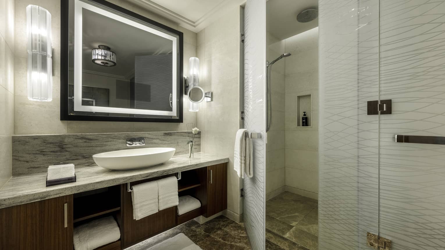 Hotel bathroom with frosted-glass walk-in shower