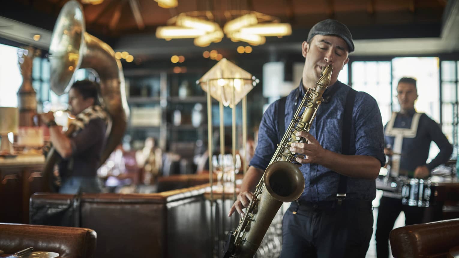 A live jazz band member plays the saxophone at Butcher & Still