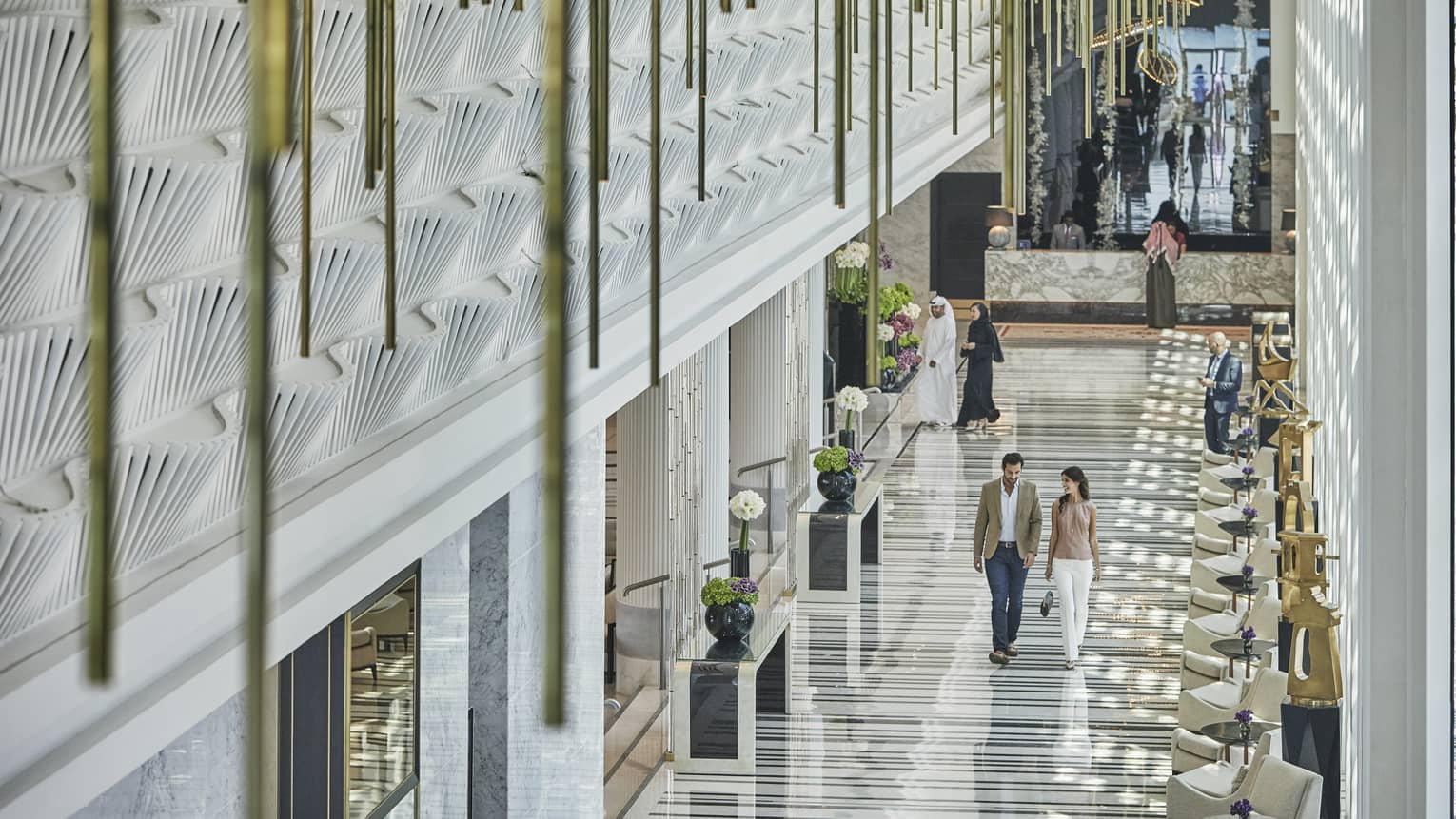 Man and woman walking in the lobby
