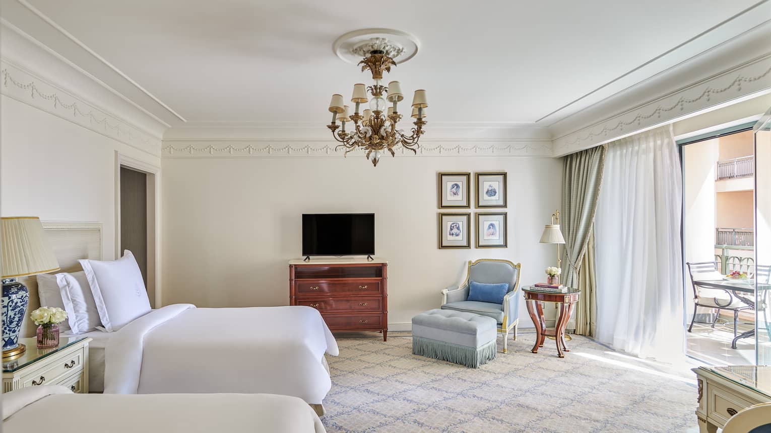 City View Room with two full-size beds, armchair and ottoman, sliding glass door to veranda