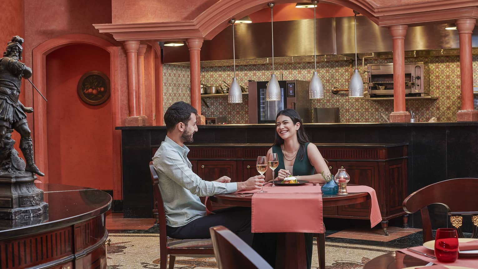 Couple enjoys a glass of wine at Stefano's, red accents