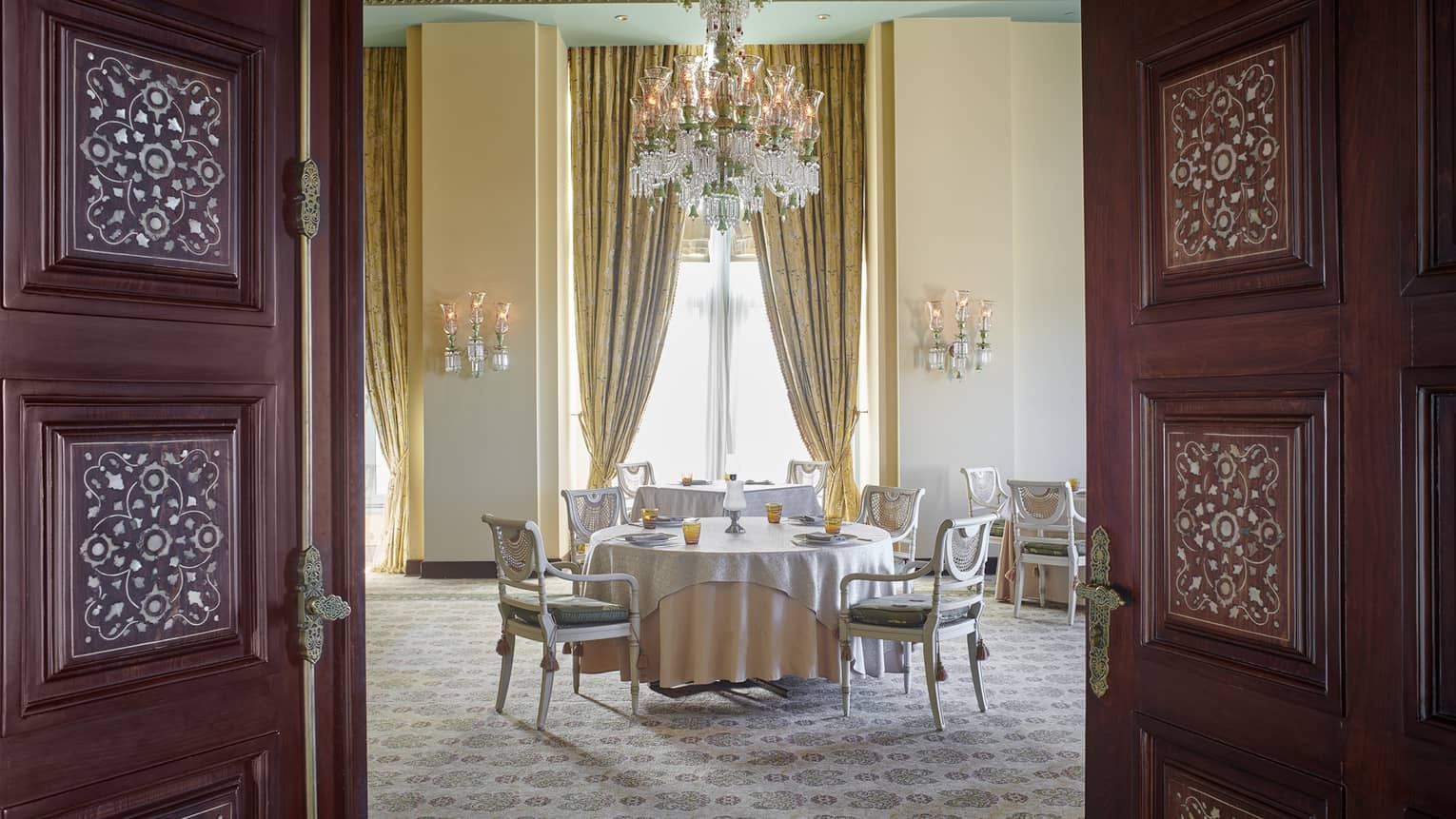 Byblos Restaurant dining area with gold curtains and chandelier