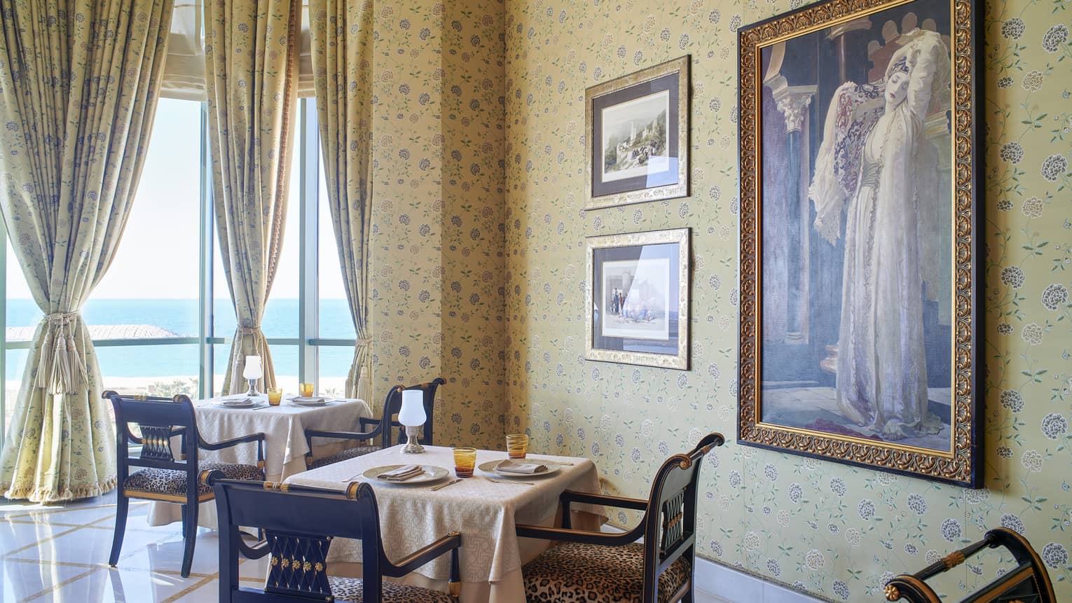 Dining room at Byblos Restaurant with gold curtains and views of the Mediterranean