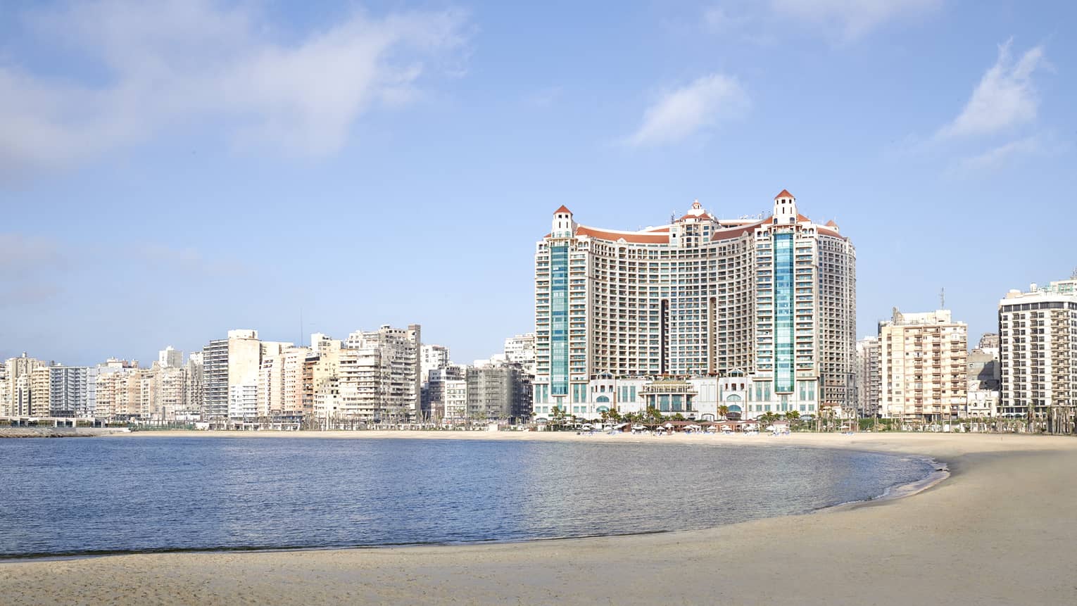Hotel exterior against backdrop of the city on the beach