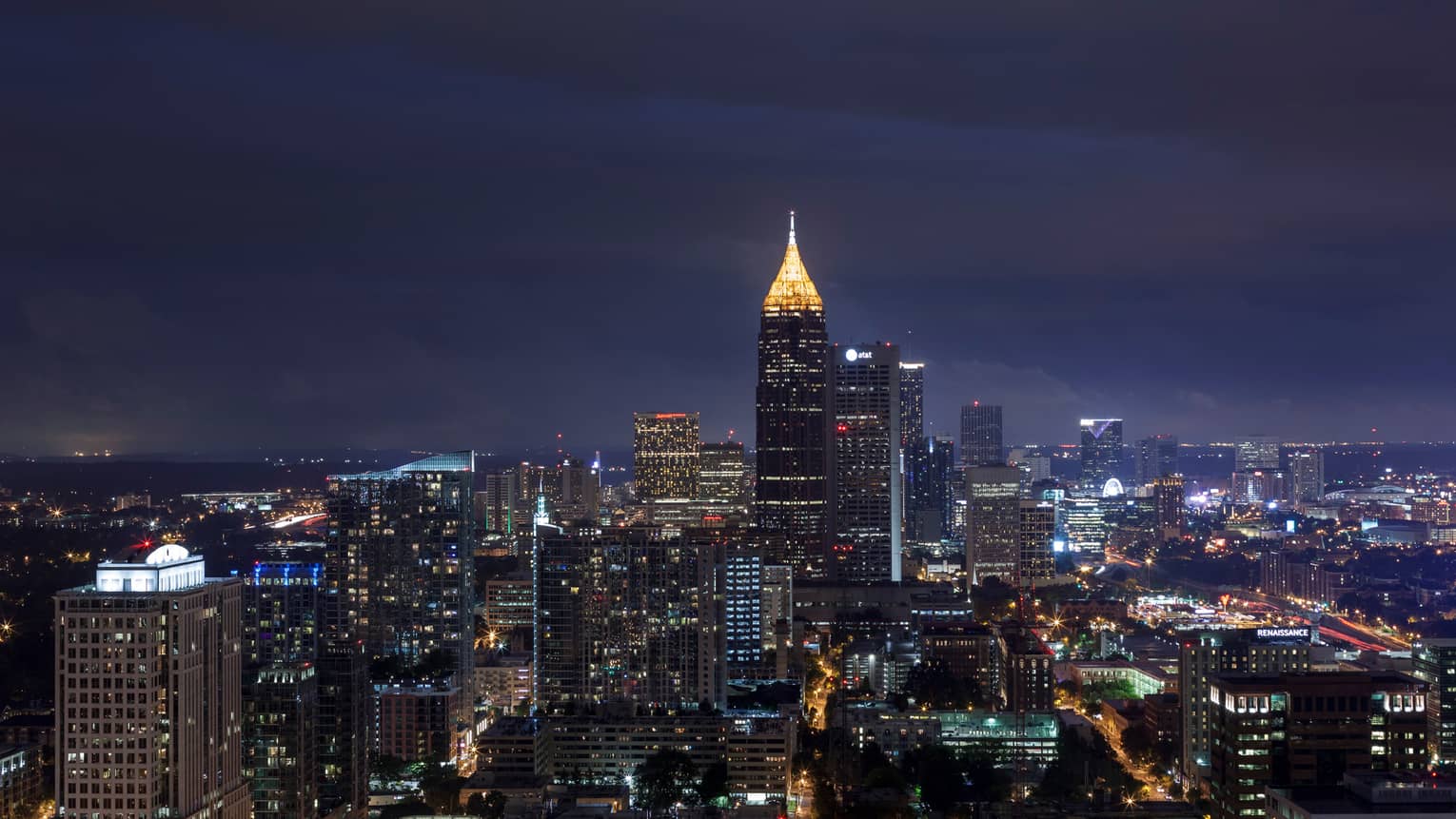 Looking down over Atlanta skyline at night with skyscrapers, Bank of America Plaza tower lit up 