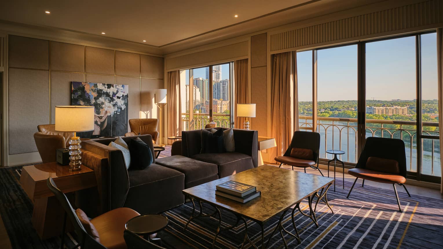 Large hotel suite living room featuring sofa and four chairs all facing a large coffee table