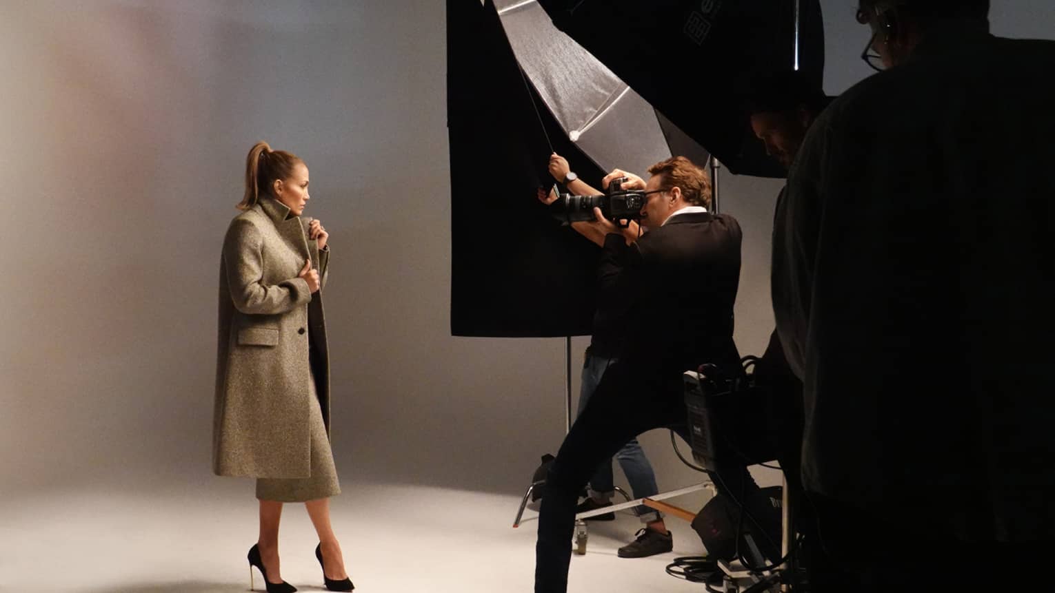 A woman in a coat in a photoshoot.