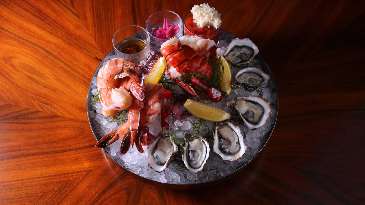 Seafood including oysters, shrimp and crab on ice.
