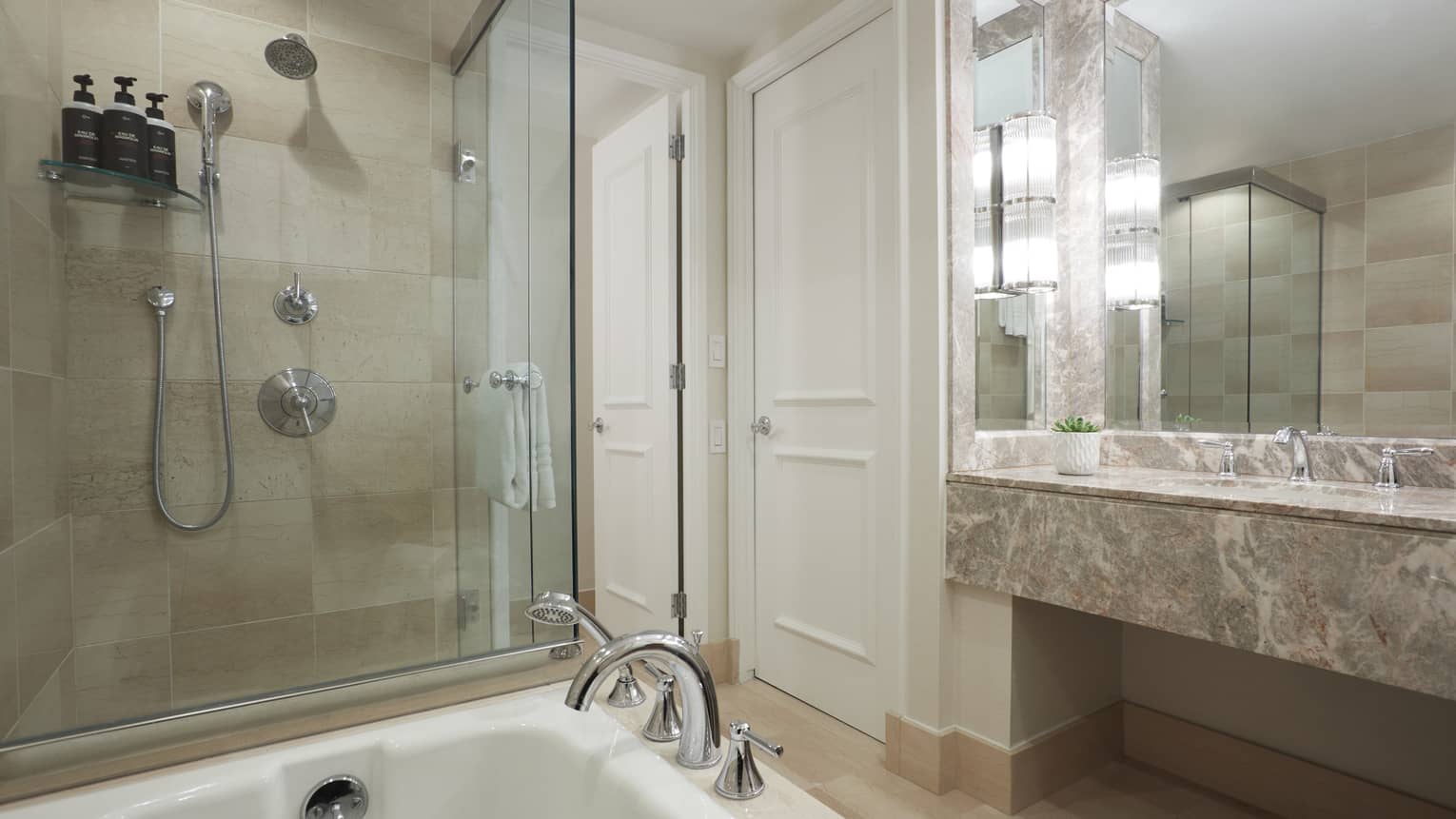 Bathroom with tub and separate glass shower, marble vanity