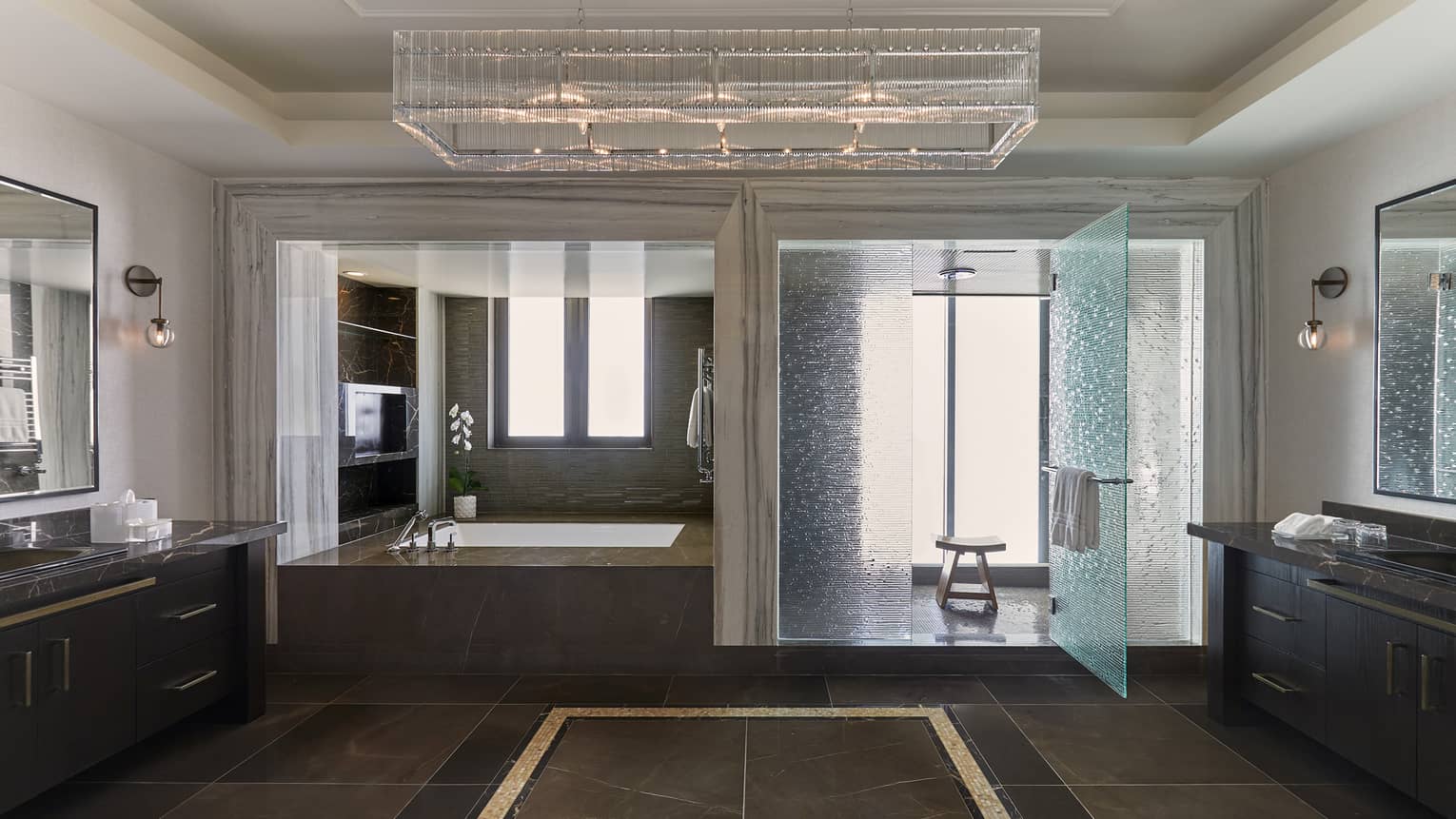 Large bathroom with walk-in shower, deep soaking tub, vanities on each side of the room