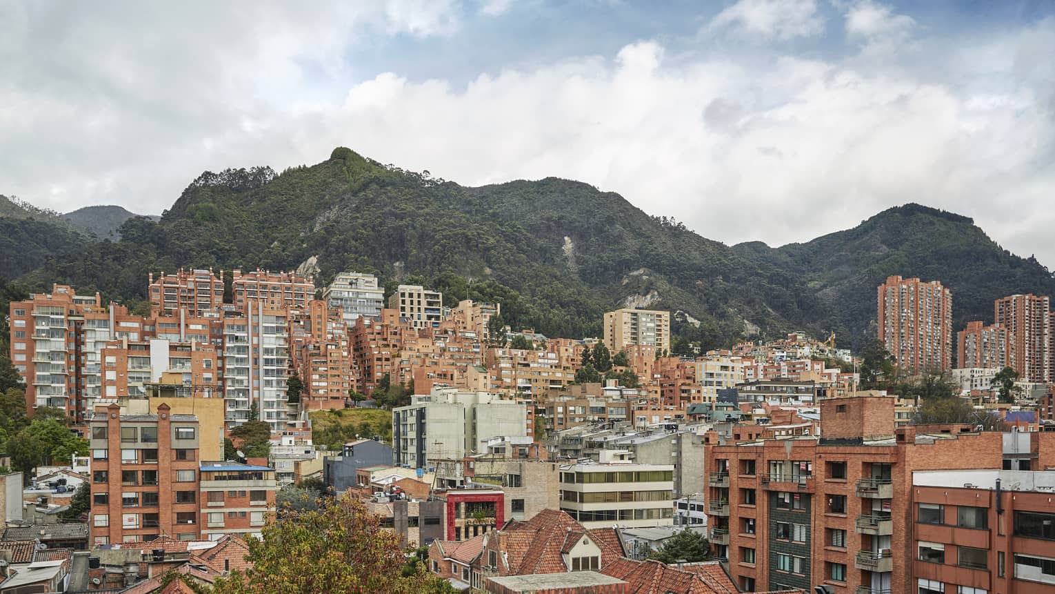 View of Bogota city skyline with buildings in front of tall mountains