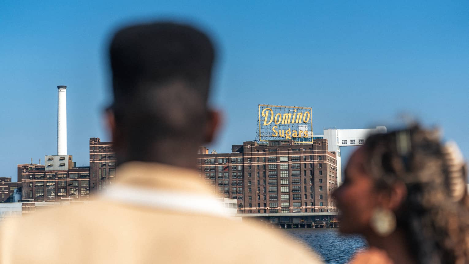 Two guests on a boat looking out to the city