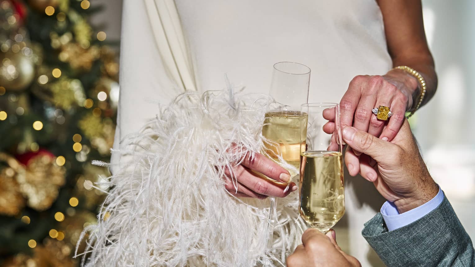 Two people holding glasses of champagne.