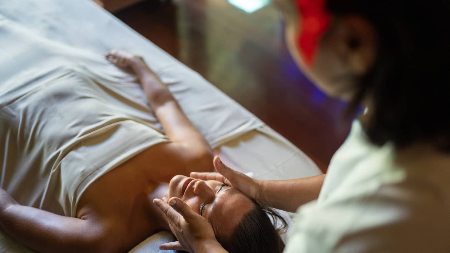 Female guest enjoys a facial at Te Mahana Spa