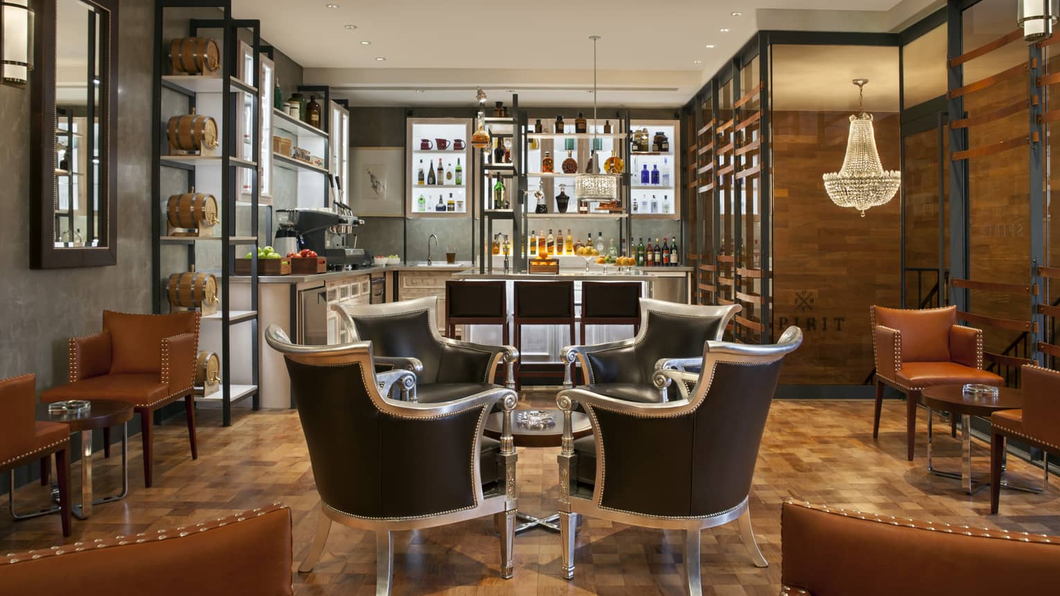 Intimate meeting room with four ornate arm chairs facing each other, with bar