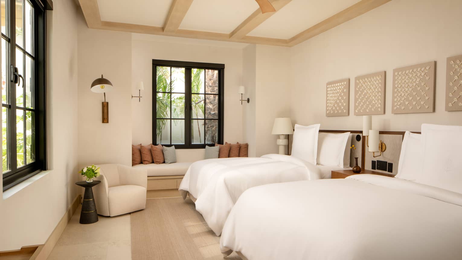 Luxury villa bedroom with two beds and beamed ceiling