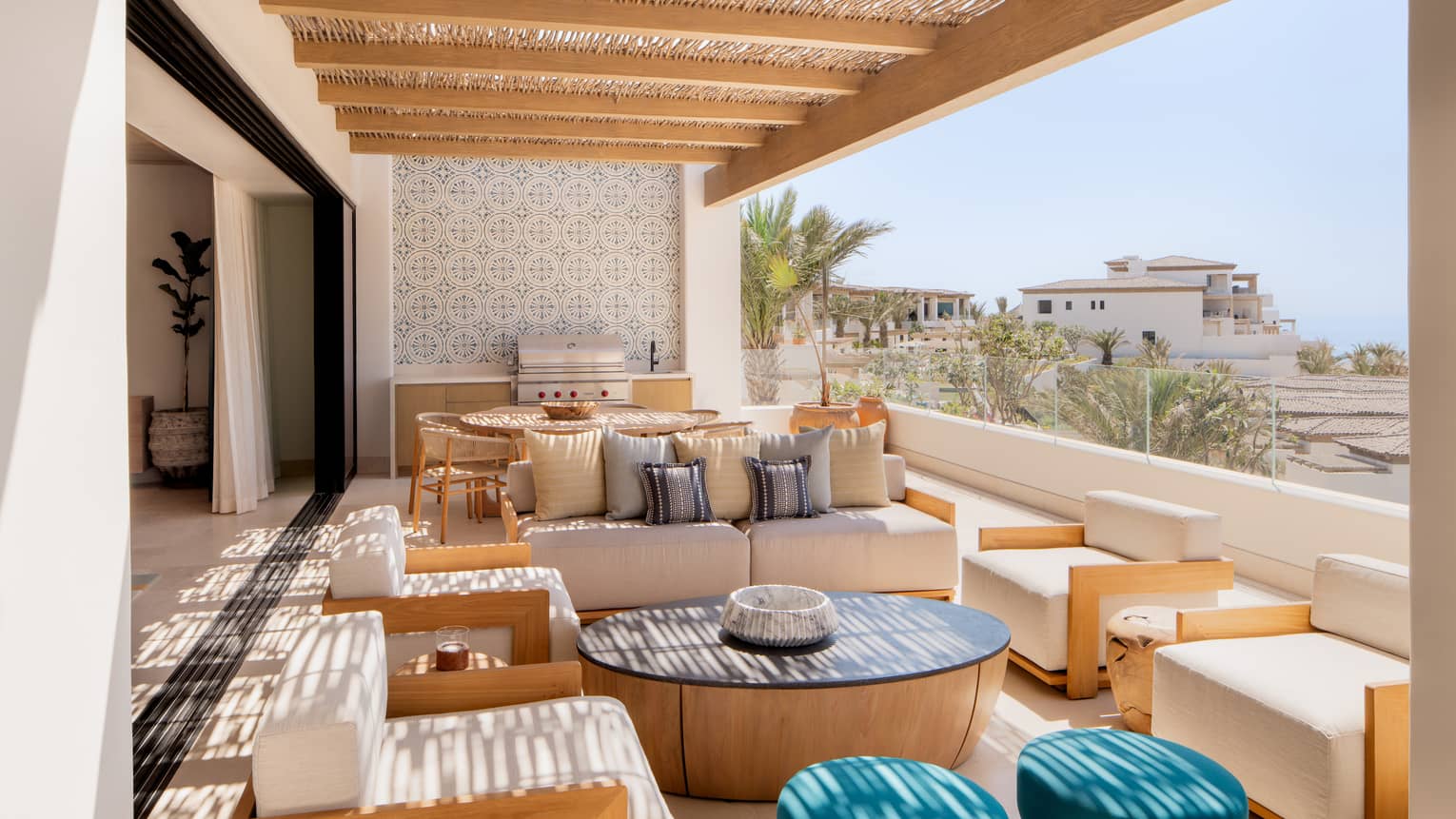 Covered ocean-view terrace of luxury villa, with lots of lounge seating, dining table and grill, at Four Seasons Resort Cabo San Lucas at Cabo Del Sol