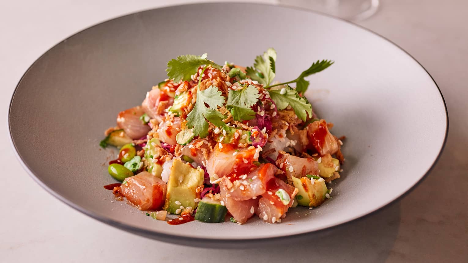 Raw tuna and vegetables in a bowl.
