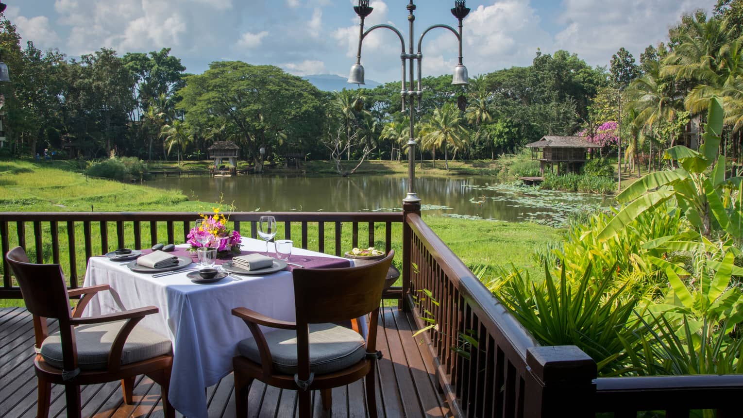 Dining table for two on Terraces patio corner overlooking pond