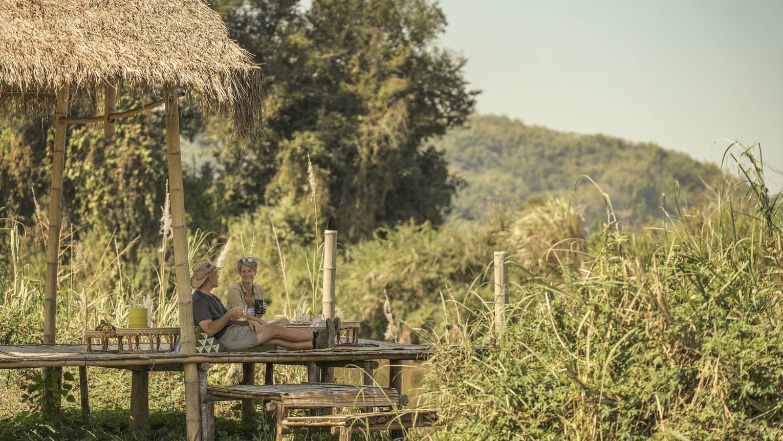 Couple enjoys a camp picnic in the Thai wilderness