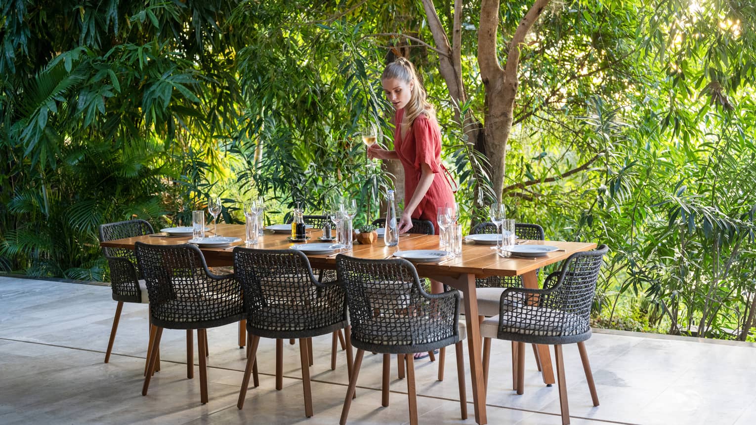 Woman setting table on outdoor patio