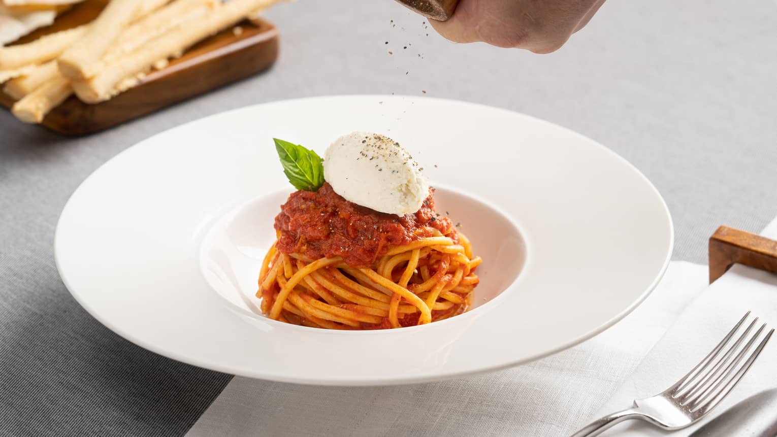 Spaghetti Pomodoro Burrata in a white, large-rimmed bowl