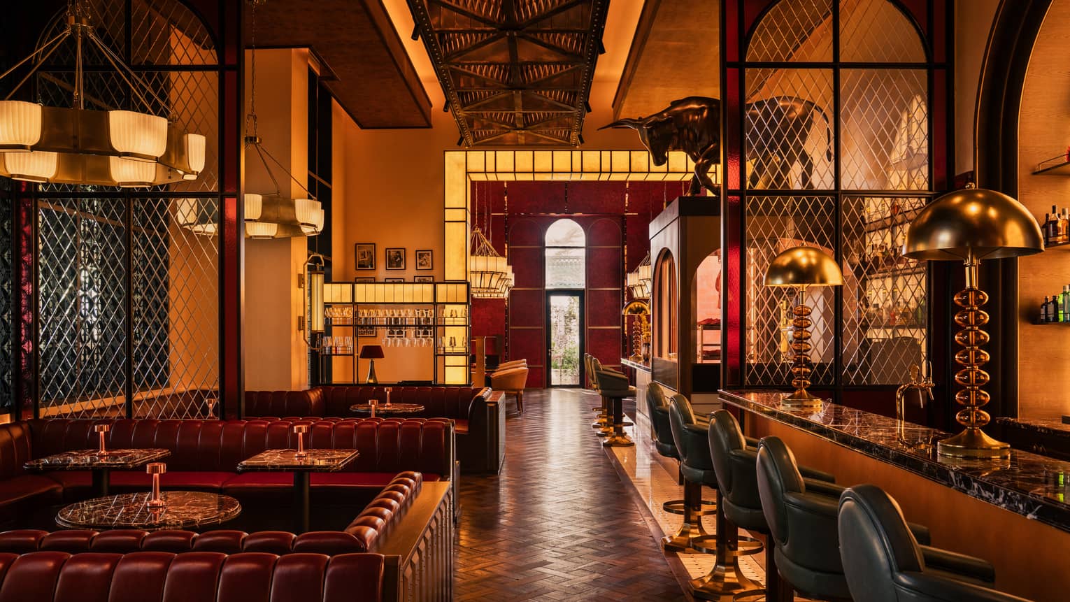 Restaurant dining rool with leather booths and dark wood decor