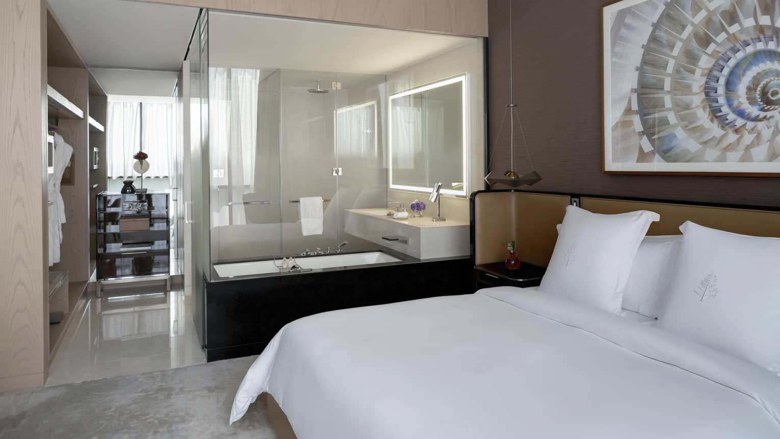 Bedroom with king bed, open bathroom with tub