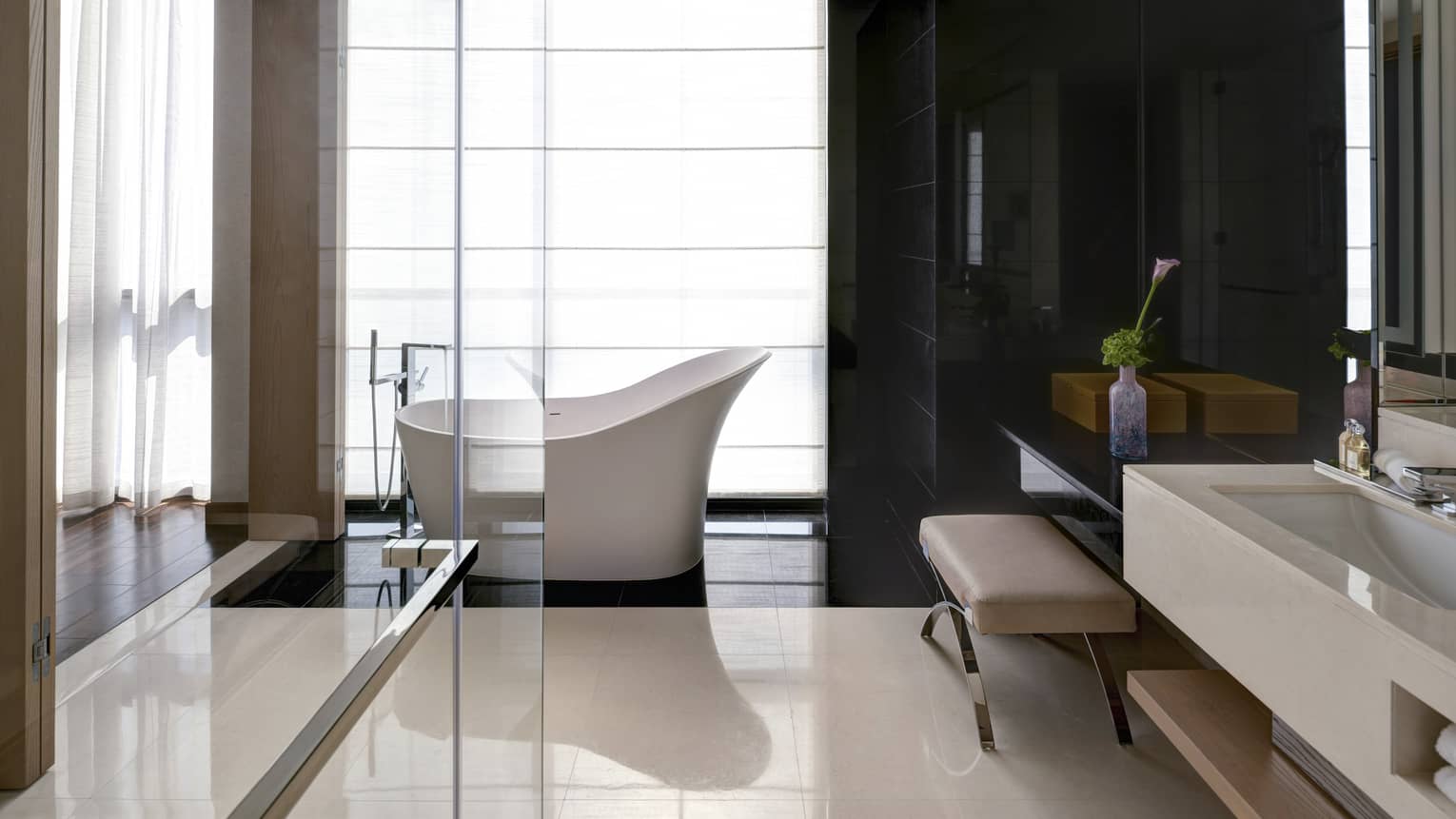 Bathroom with marble floors, glass shower, freestanding tub
