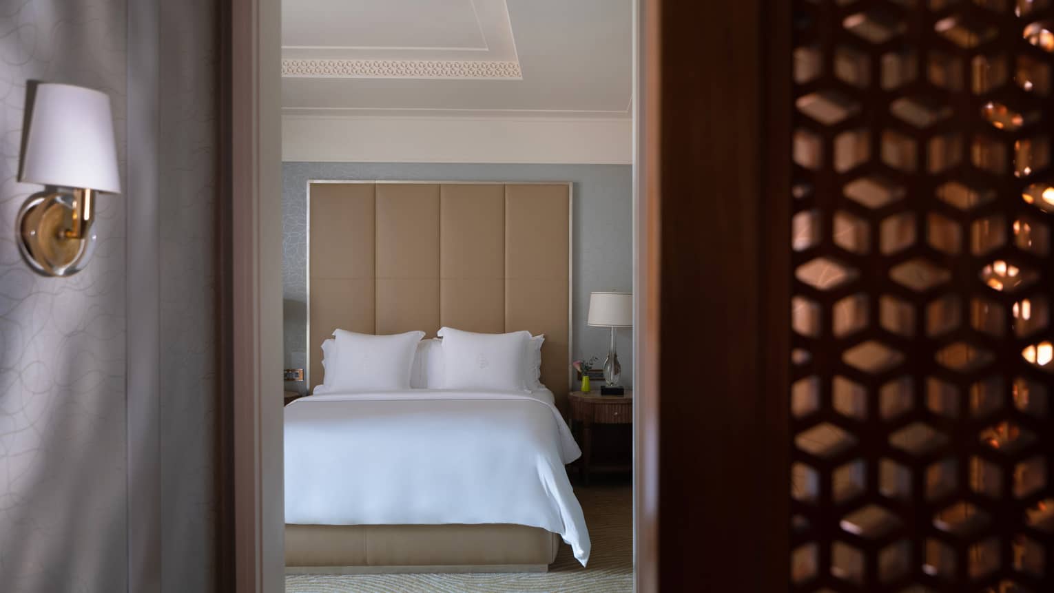 Entryway into bedroom, large tan headboard