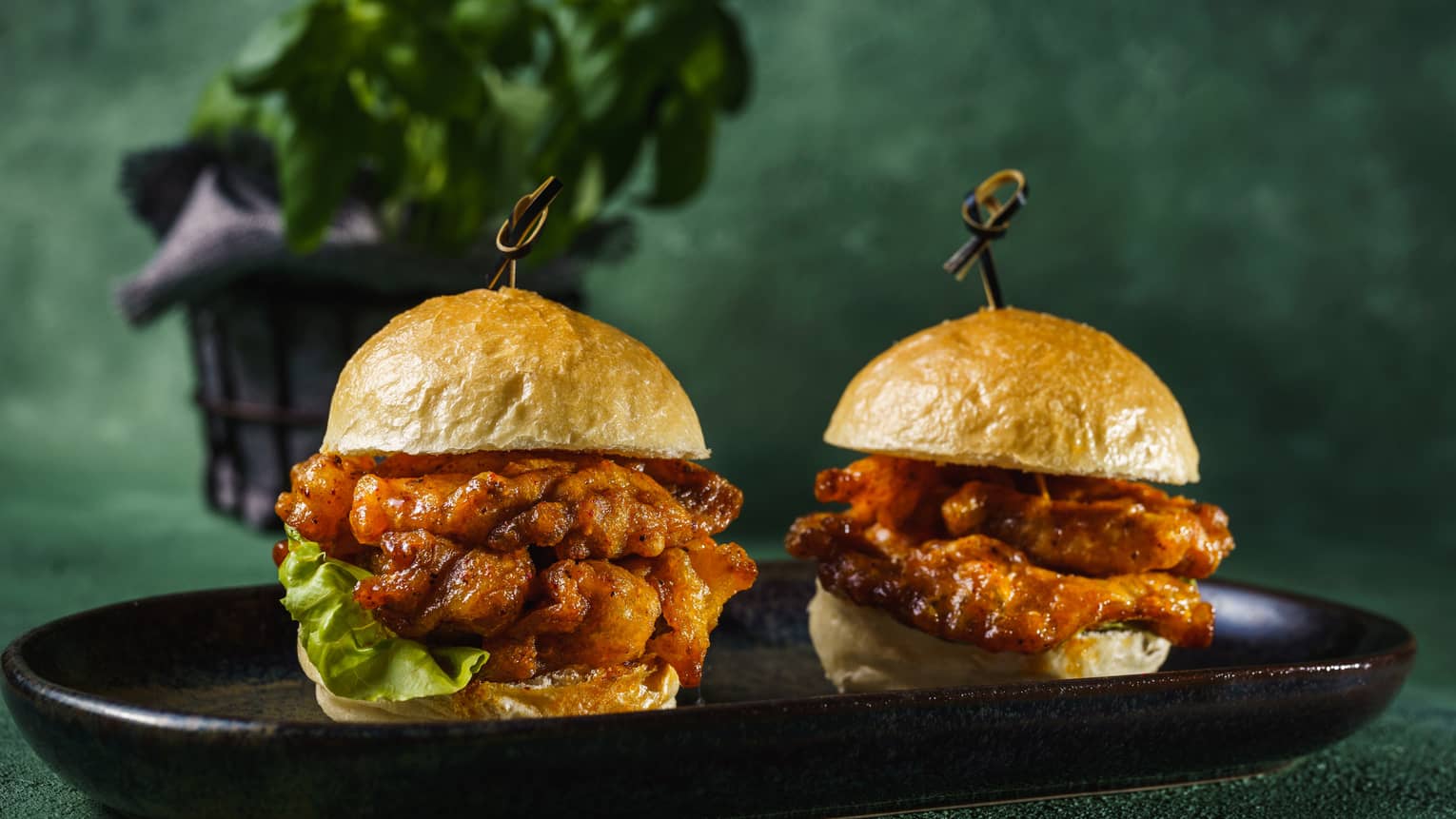 Two crispy buns filled with braised mushrooms and greenery.