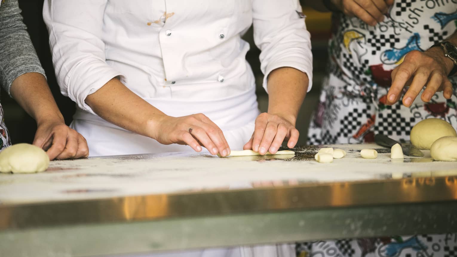 A chef demonstrates shaping pasta dough