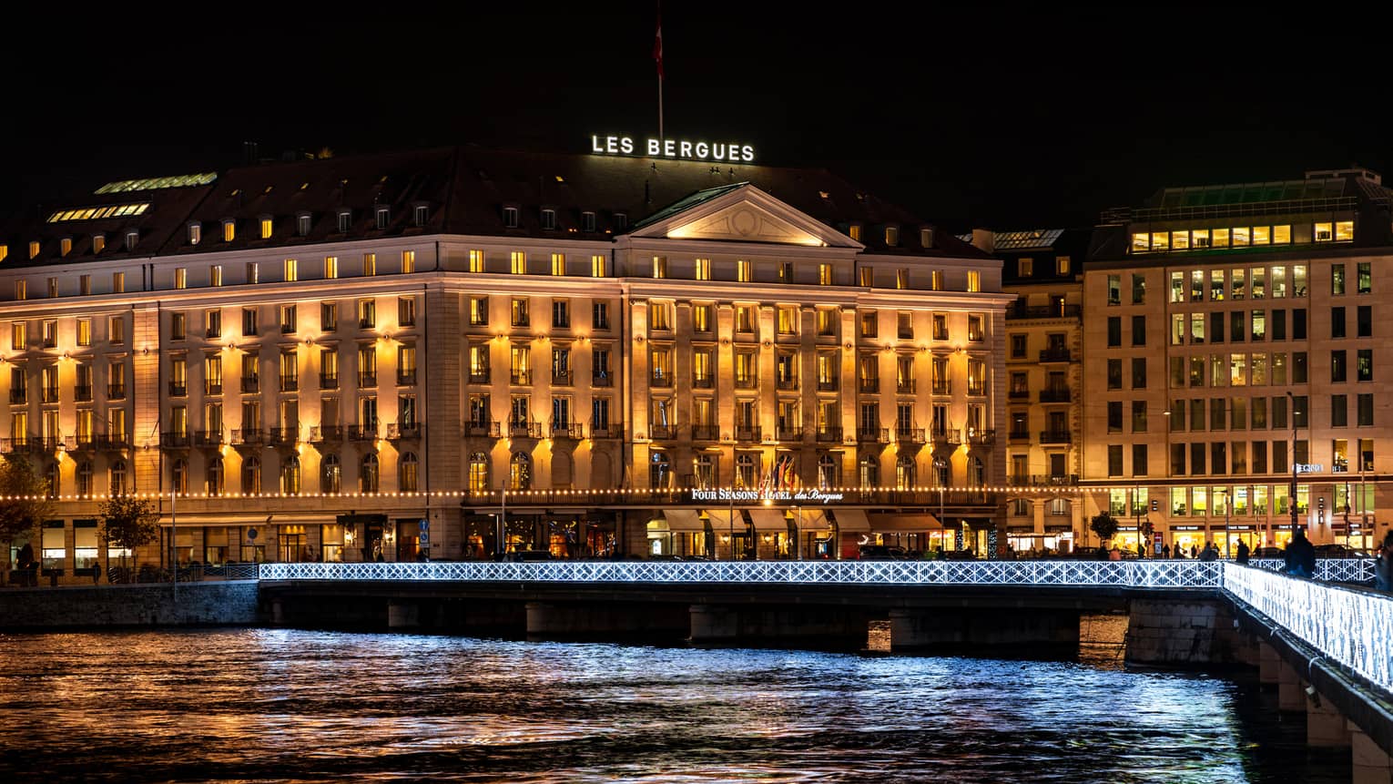 Four Seasons Hotel Des Bergues Geneva exterior illuminated at night