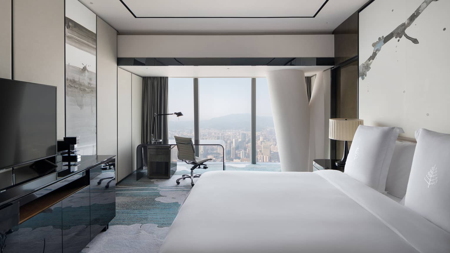 Tower King City View Room with cream and blue accents, desk by floor-to-ceiling window with natural light